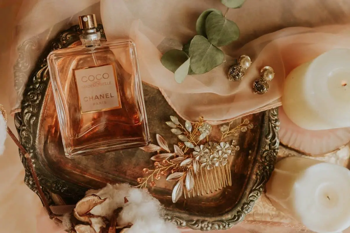A bottle of perfume beautifully kept with other items