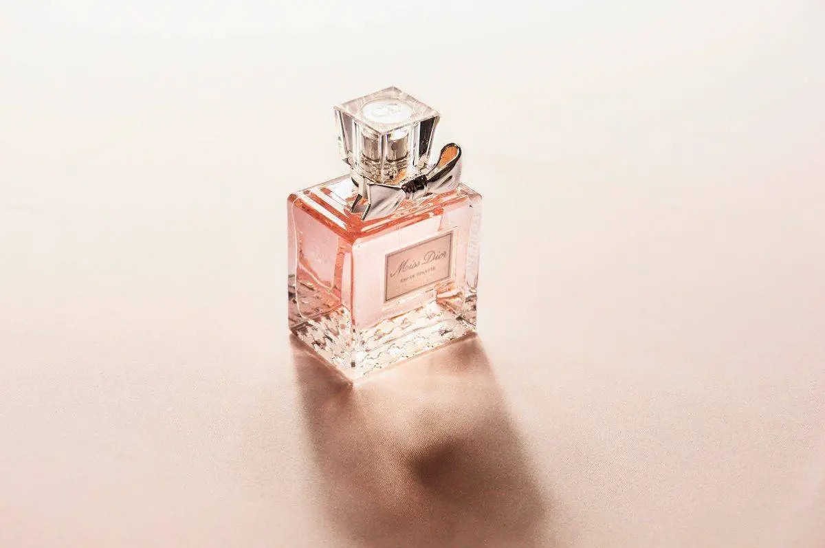 A perfume bottle with a bow