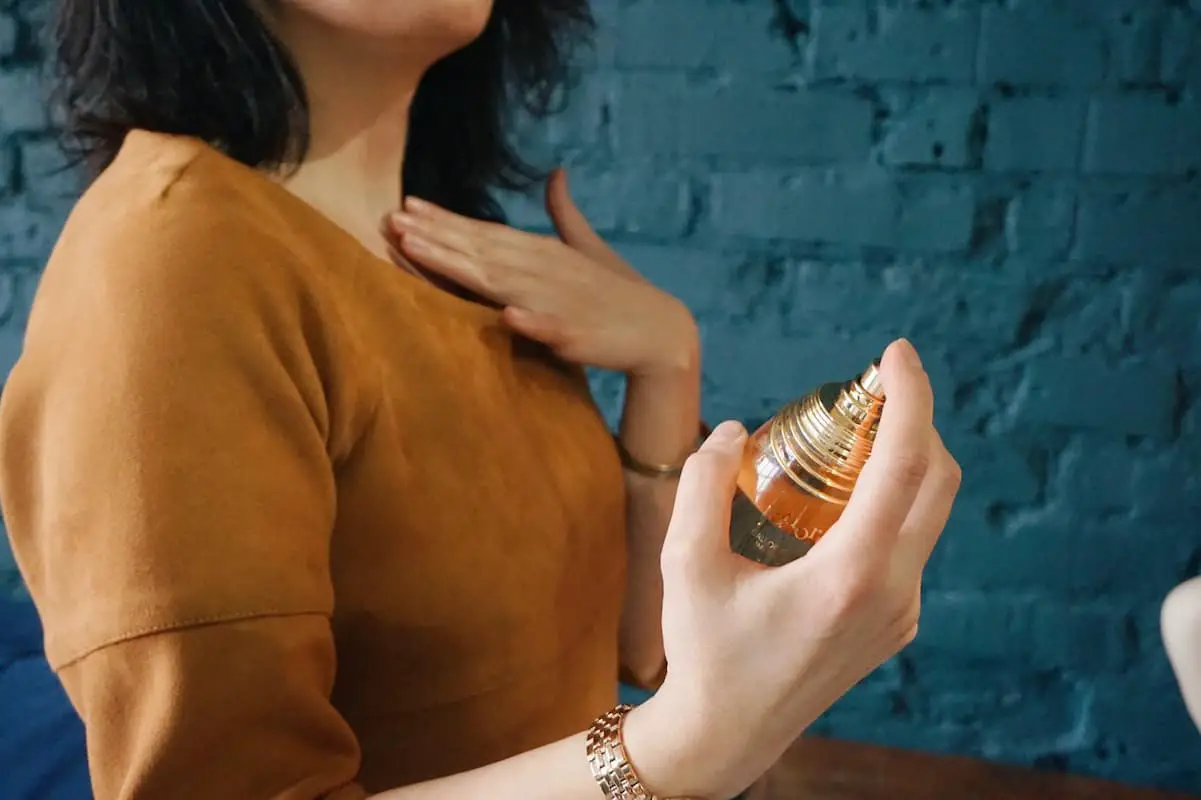 Woman using perfume